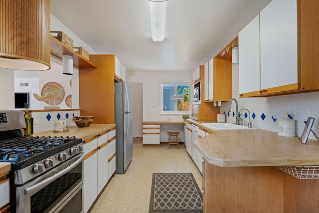 7234 Del Norte Dr, Goleta, CA 93117 - kitchen featuring stainless steel appliances, backsplash, light countertops, white cabinetry, and light flooring