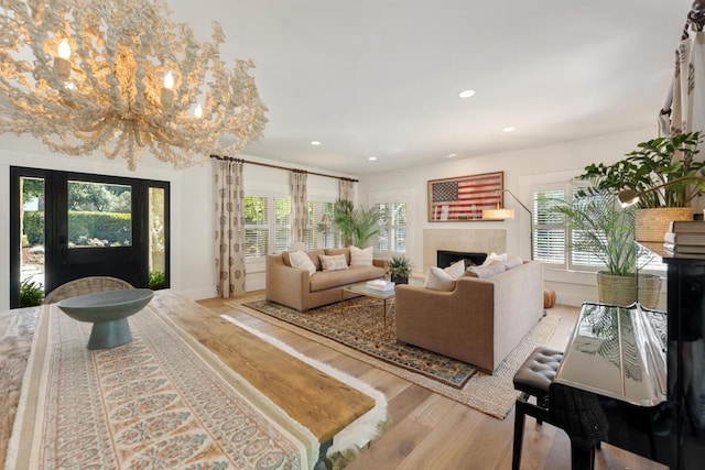2807 Gaviota St, Los Olivos, CA 93441 - living room with wood finished floors, healthy amount of natural light, a fireplace, recessed lighting, and a chandelier