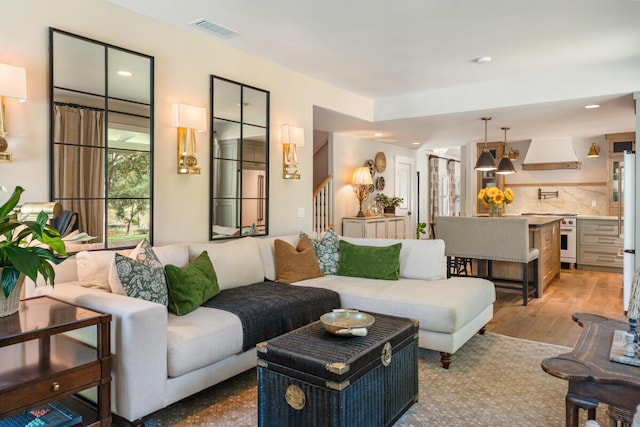 2807 Gaviota St, Los Olivos, CA 93441 - living room with light wood-style floors, recessed lighting, and stairway