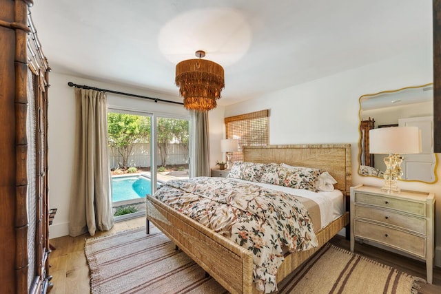 2807 Gaviota St, Los Olivos, CA 93441 - bedroom with access to exterior, wood finished floors, and a chandelier