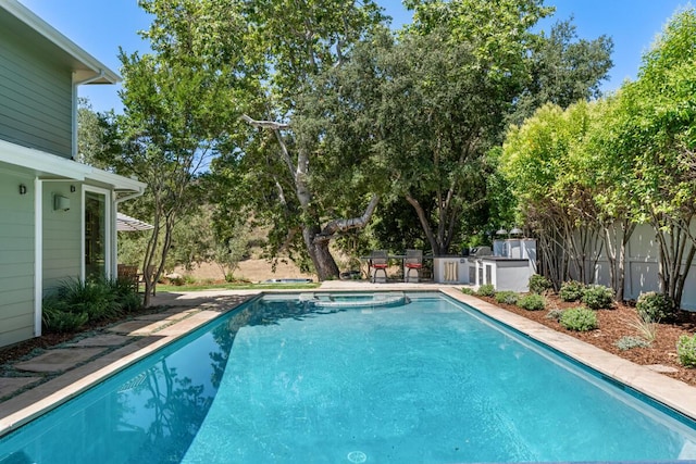 2807 Gaviota St, Los Olivos, CA 93441 - view of swimming pool featuring a pool with connected hot tub, a patio, and view of wooded area