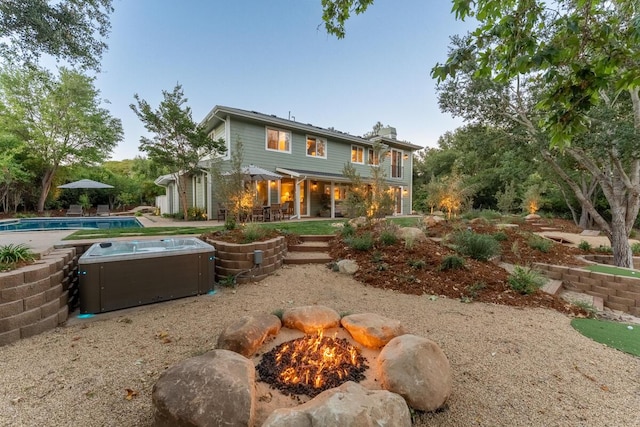 2807 Gaviota St, Los Olivos, CA 93441 - rear view of property featuring a hot tub, an outdoor pool, a patio, and a chimney