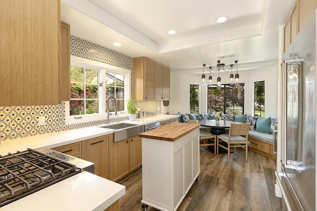 5118 Concord Pl, Carpinteria, CA 93013 - kitchen with butcher block countertops, decorative backsplash, breakfast area, dark wood finished floors, and high end fridge