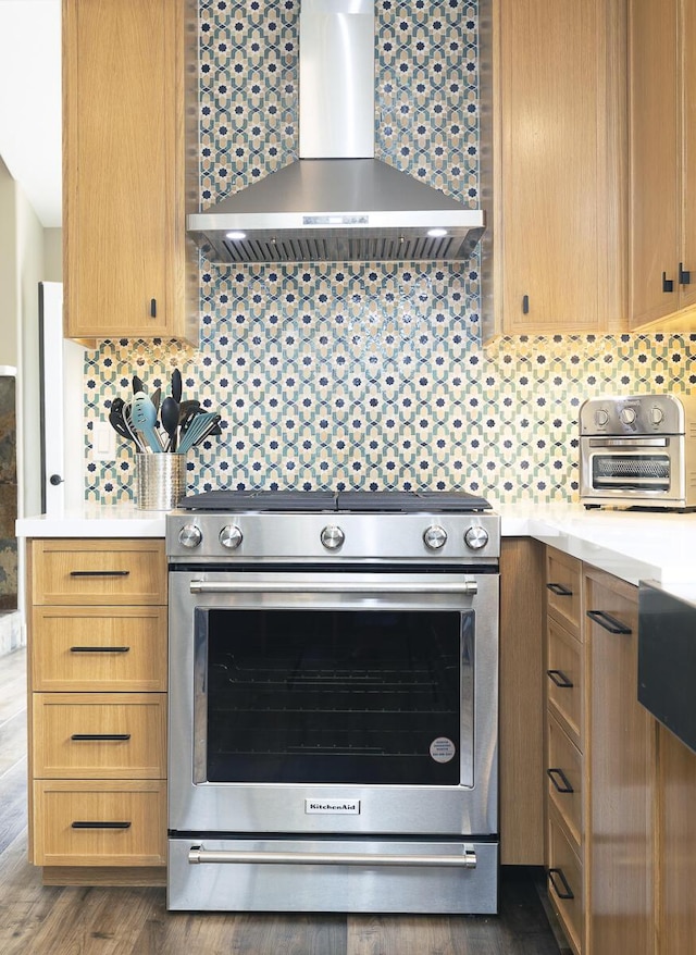 5118 Concord Pl, Carpinteria, CA 93013 - kitchen with wall chimney exhaust hood, stainless steel range with gas stovetop, light countertops, decorative backsplash, and dark wood-style flooring