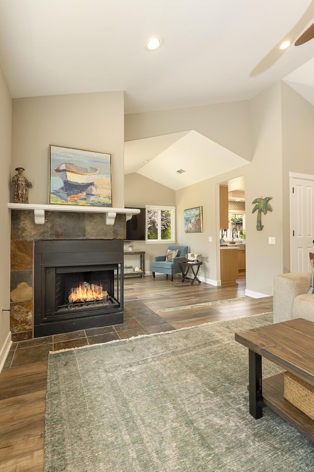 5118 Concord Pl, Carpinteria, CA 93013 - living area with lofted ceiling, a tiled fireplace, wood finished floors, recessed lighting, and a ceiling fan