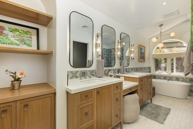 5118 Concord Pl, Carpinteria, CA 93013 - full bathroom with two vanities, a soaking tub, and decorative backsplash