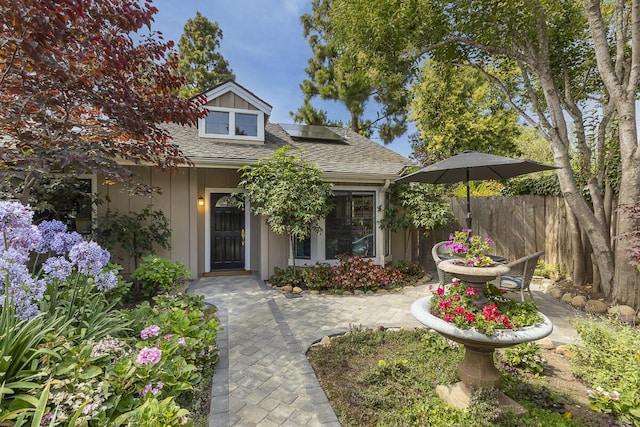 5118 Concord Pl, Carpinteria, CA 93013 - view of front of property with roof mounted solar panels and a shingled roof