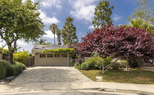 5118 Concord Pl, Carpinteria, CA 93013 - view of front facade with driveway, roof mounted solar panels, and a garage