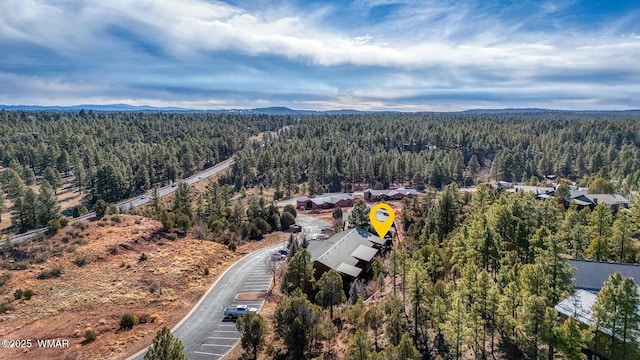 bird's eye view featuring a wooded view