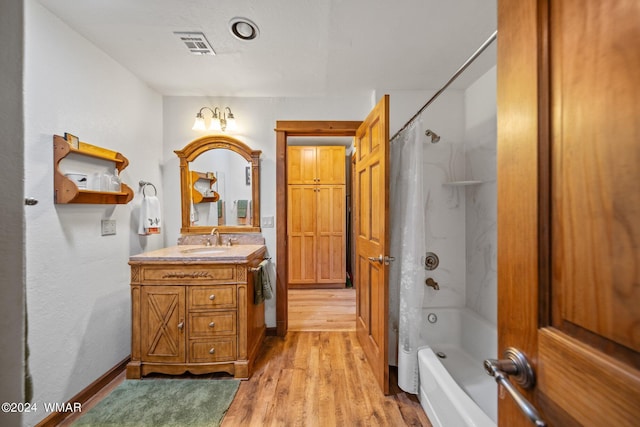 bathroom with shower / bath combination with curtain, visible vents, vanity, wood finished floors, and baseboards