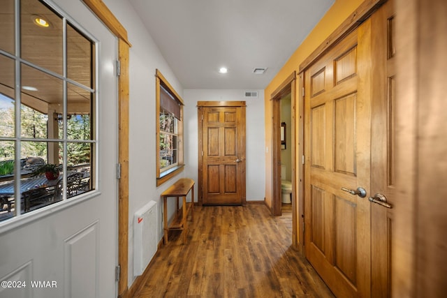 doorway featuring recessed lighting, visible vents, radiator heating unit, dark wood-type flooring, and baseboards