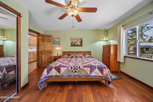 bedroom featuring ceiling fan, wood finished floors, and baseboards