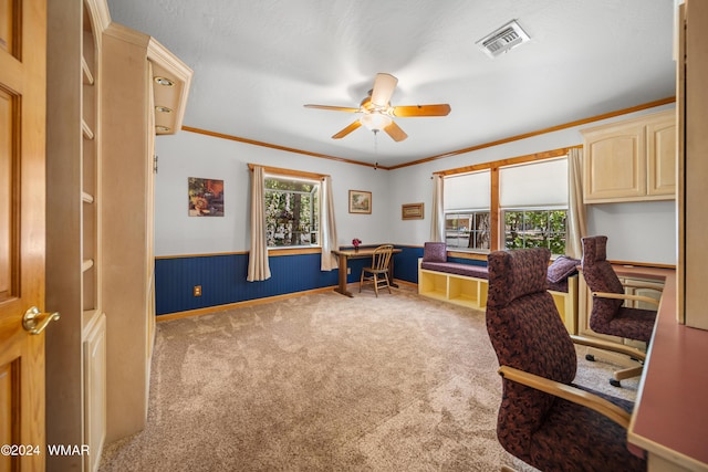 carpeted office space featuring ornamental molding, wainscoting, visible vents, and a healthy amount of sunlight