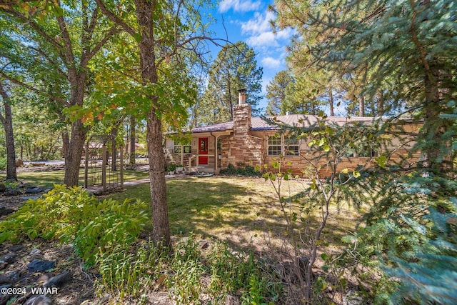 exterior space featuring a front yard and a chimney