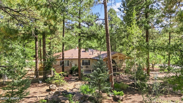 back of property featuring fence and stucco siding