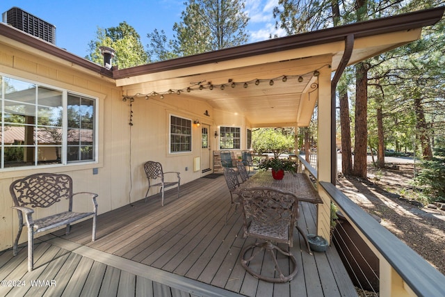 wooden terrace featuring outdoor dining area