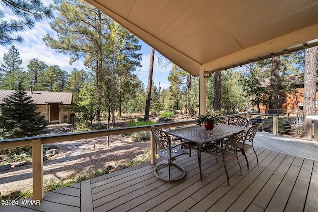 wooden deck featuring outdoor dining area