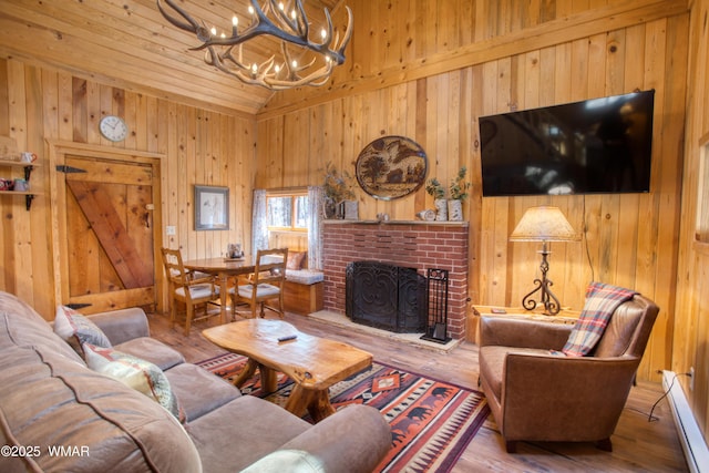 1862 Douglas Fir Dr, Pinetop, AZ 85935 - living area featuring a chandelier, wooden walls, wood finished floors, a fireplace, and high vaulted ceiling