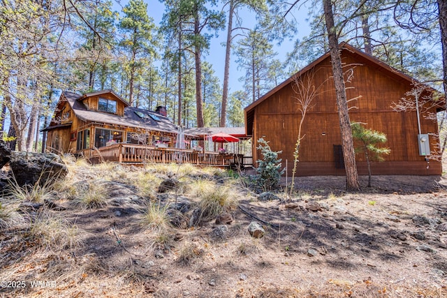 1862 Douglas Fir Dr, Pinetop, AZ 85935 - back of house featuring a wooden deck and a chimney
