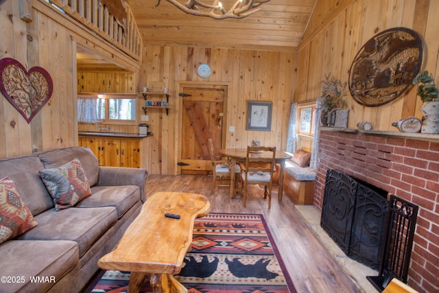 1862 Douglas Fir Dr, Pinetop, AZ 85935 - living room with wood finished floors, lofted ceiling, wooden ceiling, a brick fireplace, and wood walls