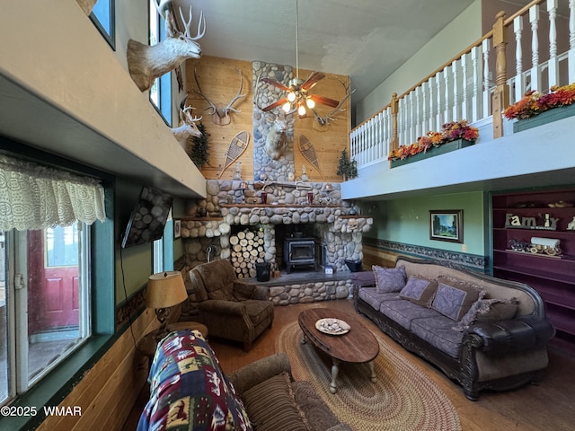 7525 E E Sherwood Rd, Snowflake, AZ 85937 - living room with a high ceiling, a wood stove, ceiling fan, and wood finished floors