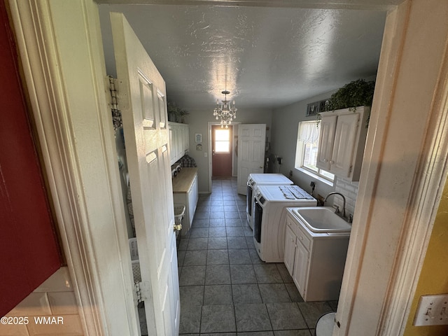 7525 E E Sherwood Rd, Snowflake, AZ 85937 - washroom featuring washer and clothes dryer, a chandelier, light tile patterned flooring, and a textured ceiling