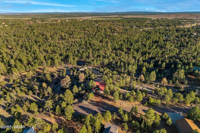 drone / aerial view featuring a forest view