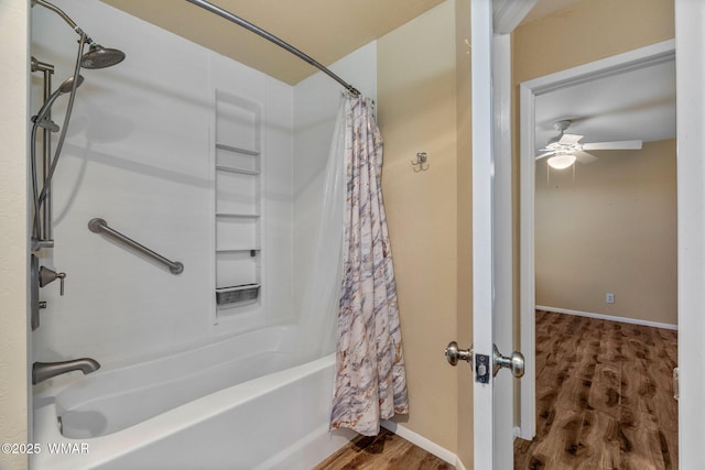 bathroom featuring baseboards, ceiling fan, shower / bathtub combination with curtain, and wood finished floors