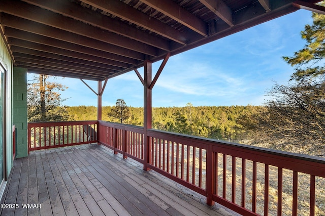 wooden terrace with a view of trees