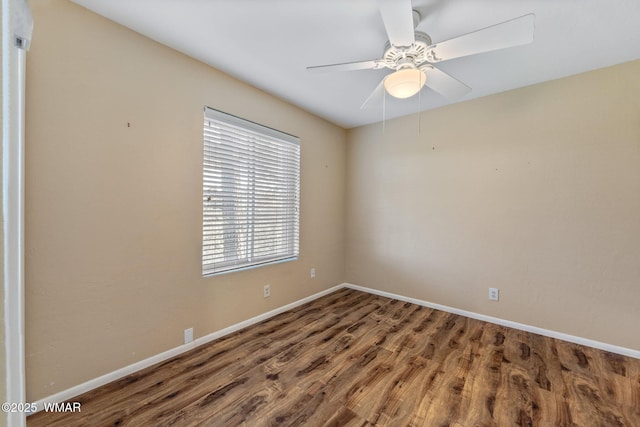 empty room featuring baseboards, a ceiling fan, and wood finished floors