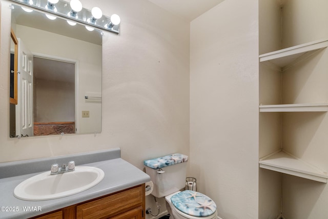 bathroom with toilet and vanity