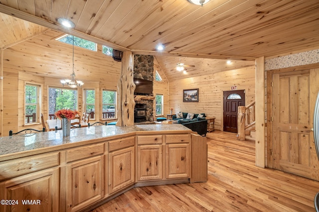 kitchen with wooden ceiling, pendant lighting, open floor plan, and tile counters