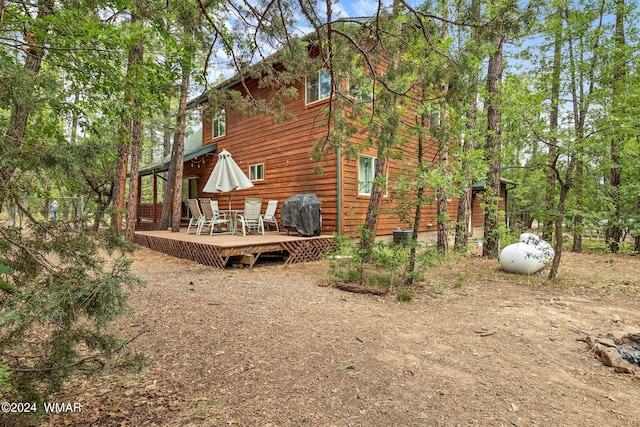 rear view of house featuring a deck