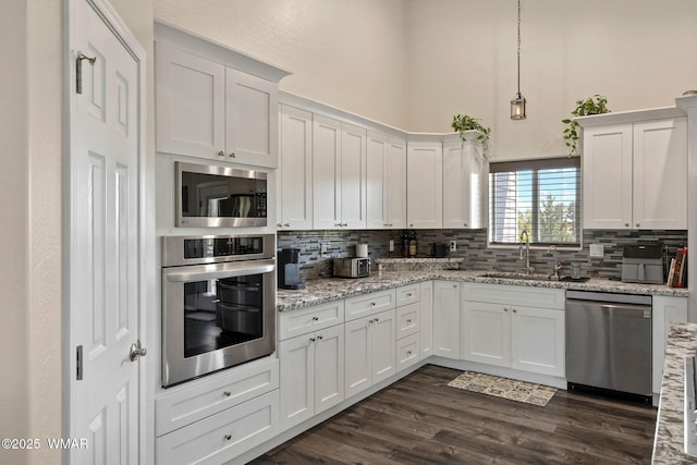 460 S Mountain Pines Ave, Show Low, AZ 85901 - kitchen featuring appliances with stainless steel finishes, tasteful backsplash, a towering ceiling, white cabinetry, and dark wood-style flooring