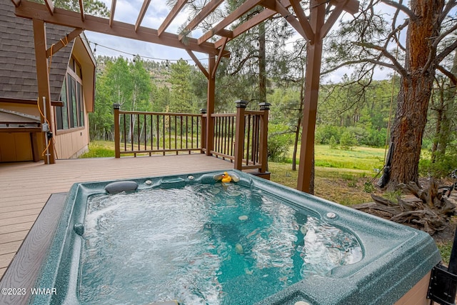 view of swimming pool featuring hot tub deck surround, a deck, and a pergola