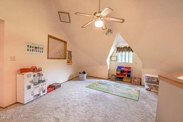 game room featuring a ceiling fan, carpet, and vaulted ceiling