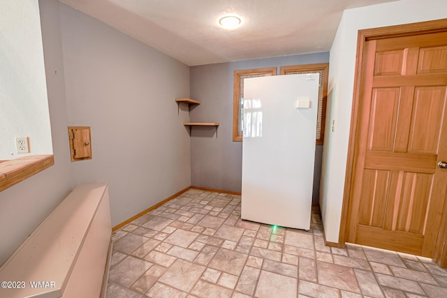 interior space with stone finish flooring and baseboards