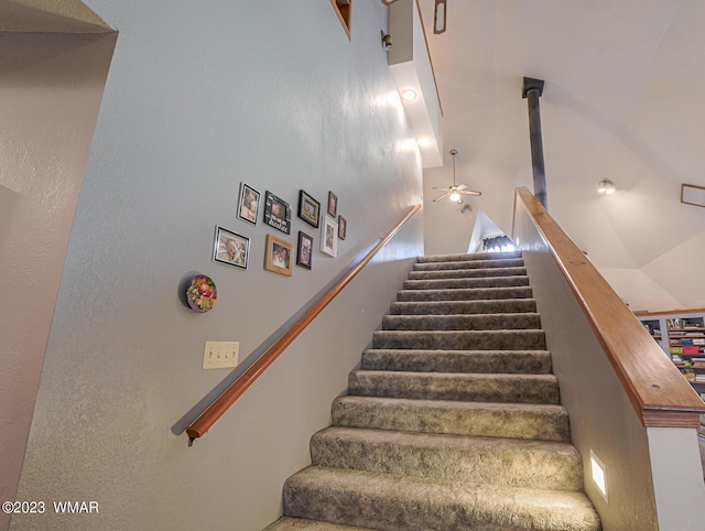 stairway featuring high vaulted ceiling