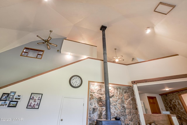 interior details with a wood stove and ceiling fan