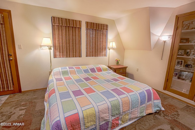 bedroom featuring vaulted ceiling and carpet flooring