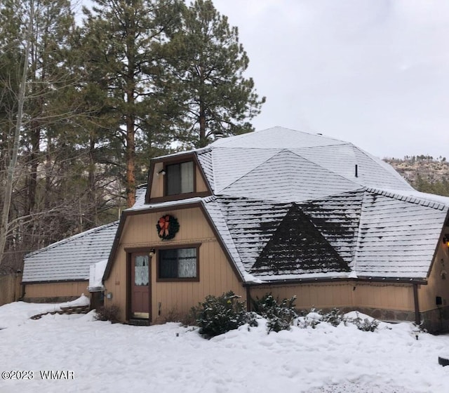 exterior space featuring roof with shingles