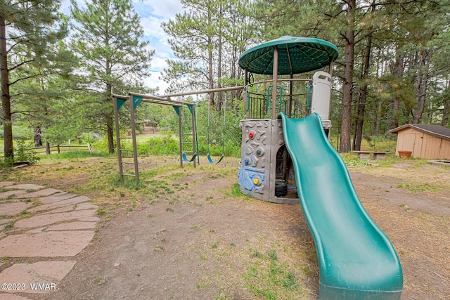 community play area with an outbuilding, a shed, and fence