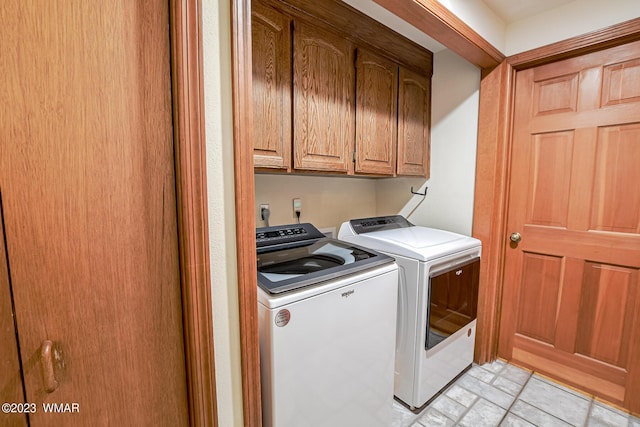laundry area with cabinet space and independent washer and dryer