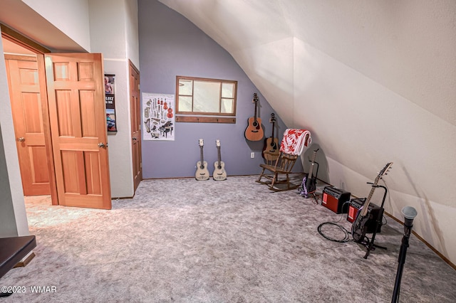 rec room featuring carpet and lofted ceiling