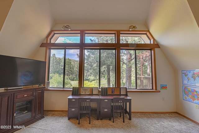 office with lofted ceiling, light carpet, and baseboards