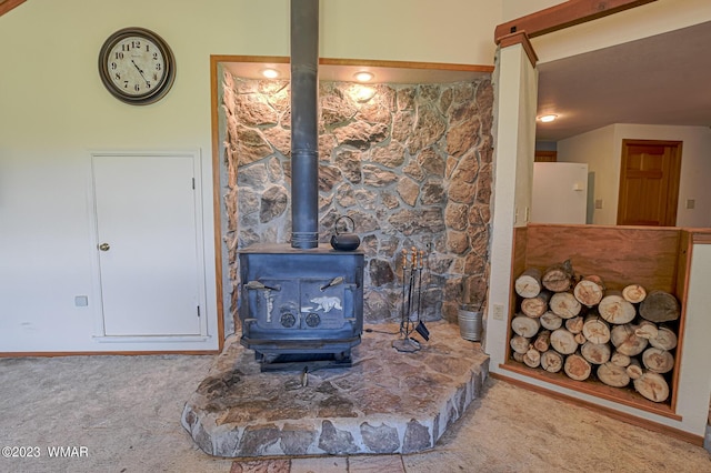 interior details with a wood stove, carpet floors, and freestanding refrigerator