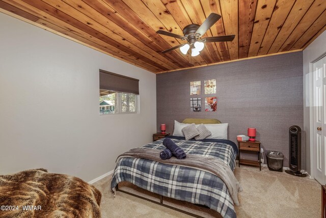 bedroom featuring baseboards, carpet, wood ceiling, and a ceiling fan