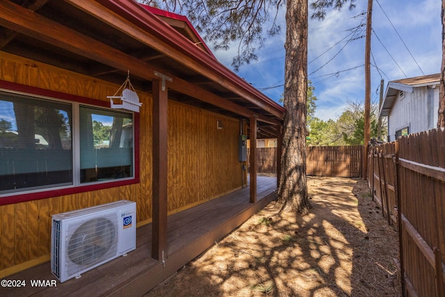 view of side of home with ac unit and a fenced backyard