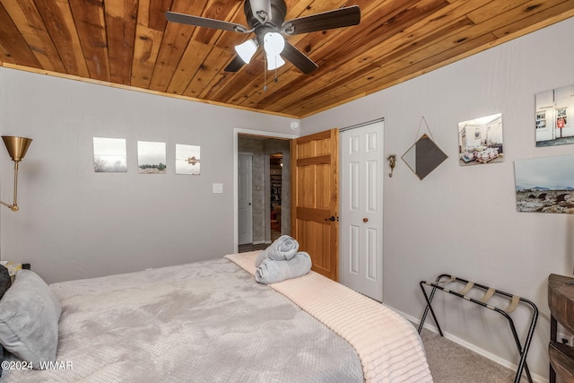 carpeted bedroom featuring wood ceiling, ceiling fan, and a closet