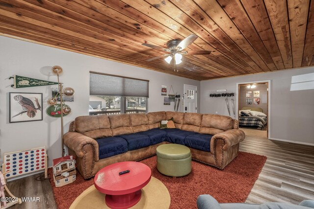 living room with wood ceiling, a ceiling fan, and wood finished floors